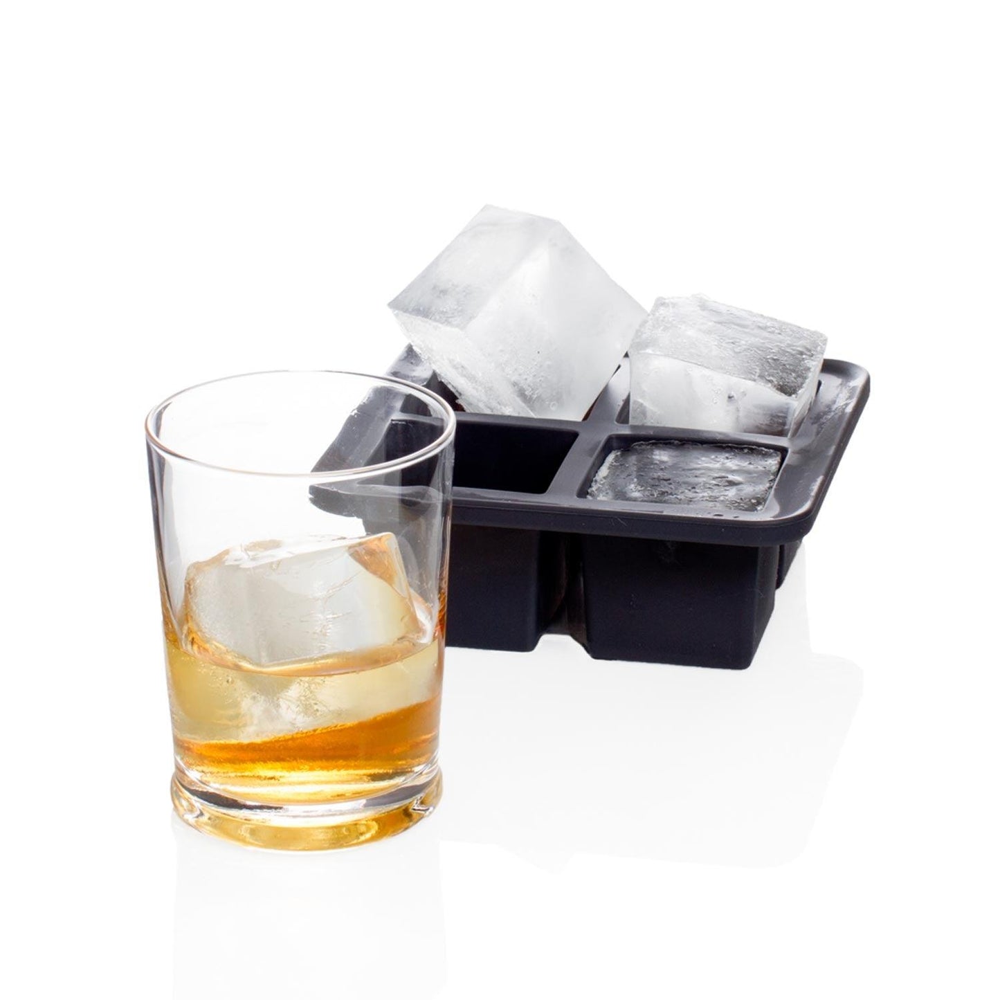 Black silicone ice cube tray with four large cubes, next to a glass of whiskey with one cube.