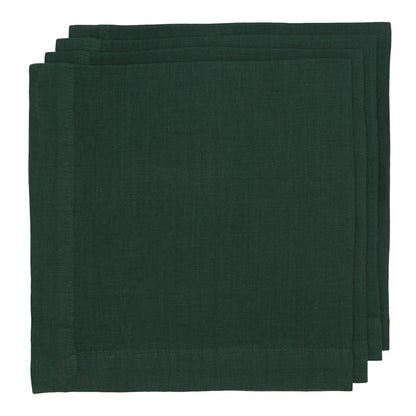 Stack of three Fir HG dark forest green hand-dyed linen napkins with mitered corners.