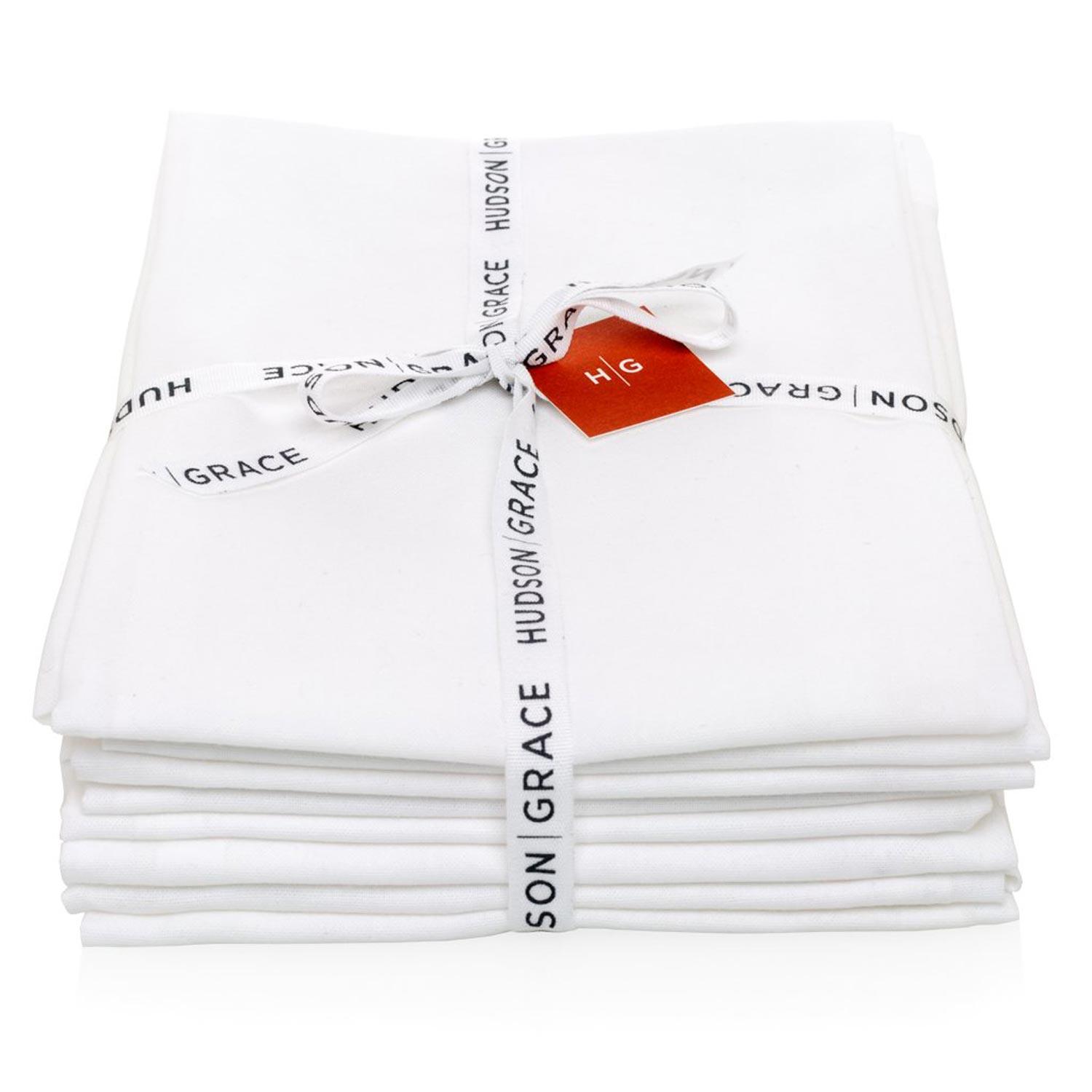 Stack of 6 white cotton HG Flour Sack Towels tied with a Hudson Grace ribbon and red tag.