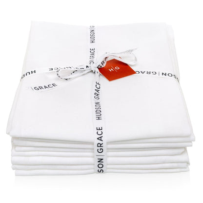 Stack of 6 white cotton HG Flour Sack Towels tied with a Hudson Grace ribbon and red tag.