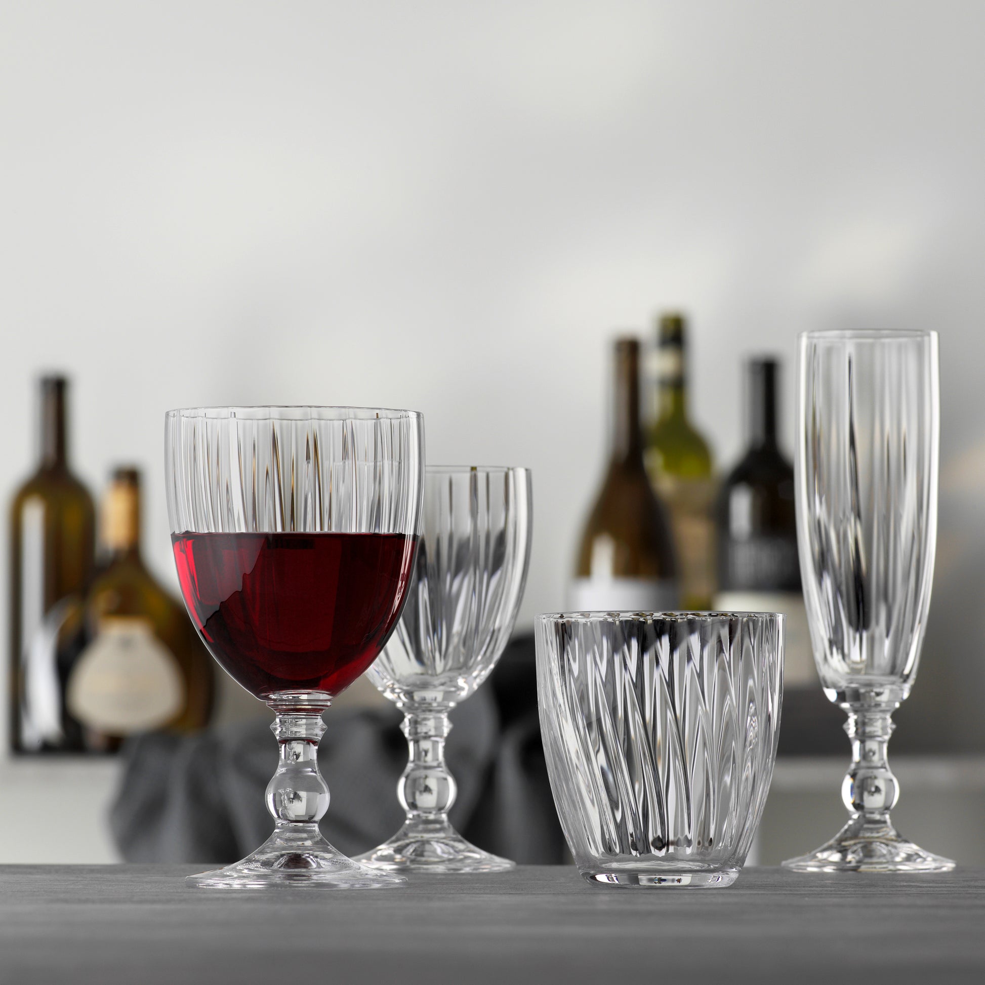 Georgia Eco-Crystal Champagne Glass, 8oz, with ribbed design, next to other clear ribbed glassware.