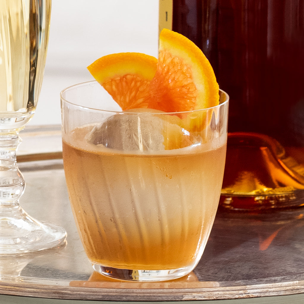 Georgia Eco-Crystal Double Old-Fashioned Glass, 9oz, with ribbed design, holding a cocktail with orange slices.