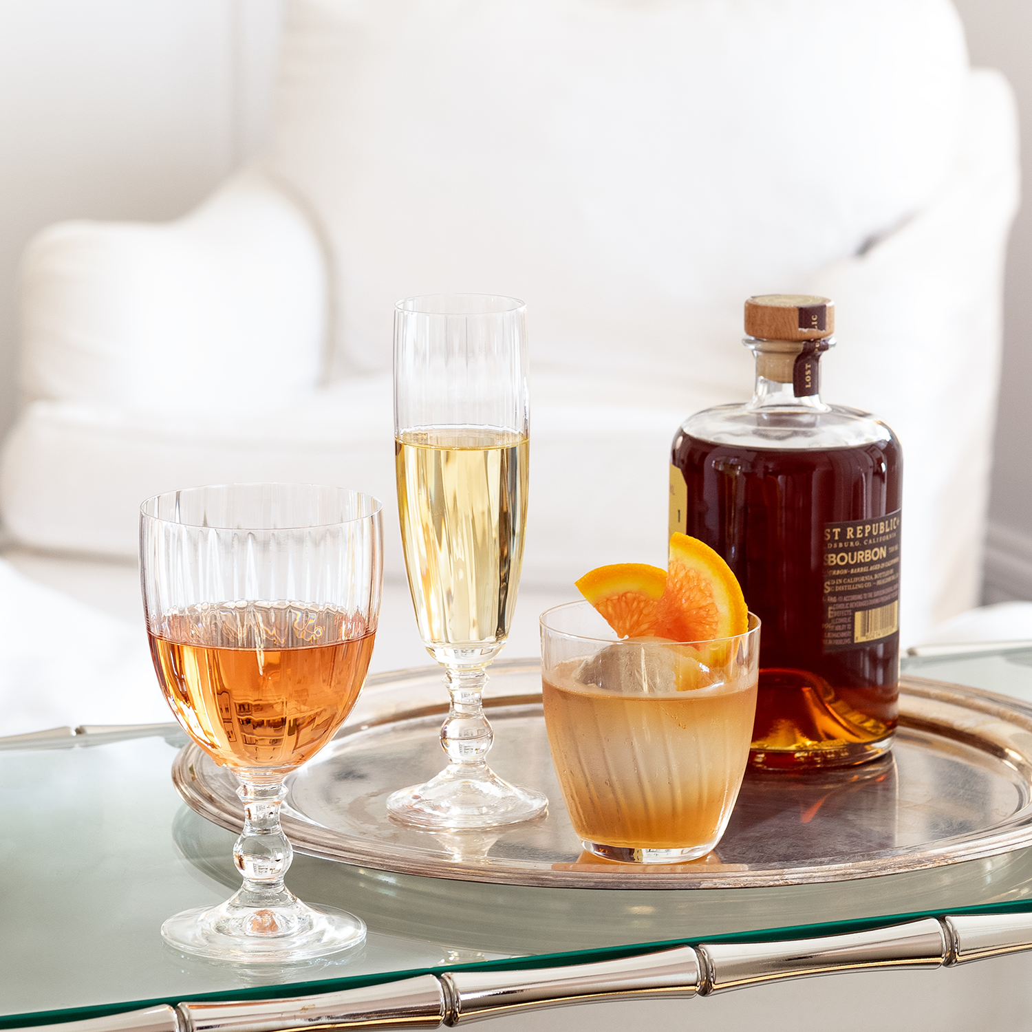 Clear ribbed Georgia Eco-Crystal Double Old-Fashioned Glass, 9oz, with an orange slice and drink.