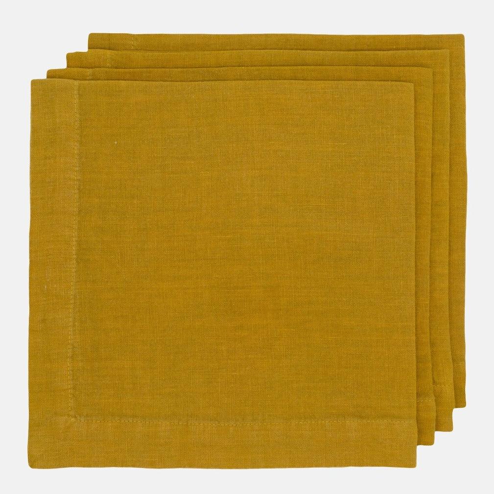 Goldenrod HG Signature hand-dyed linen napkins, 22-inch square, folded with mitered corners.
