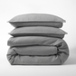 Stacked grey washed-linen duvet cover and two shams.