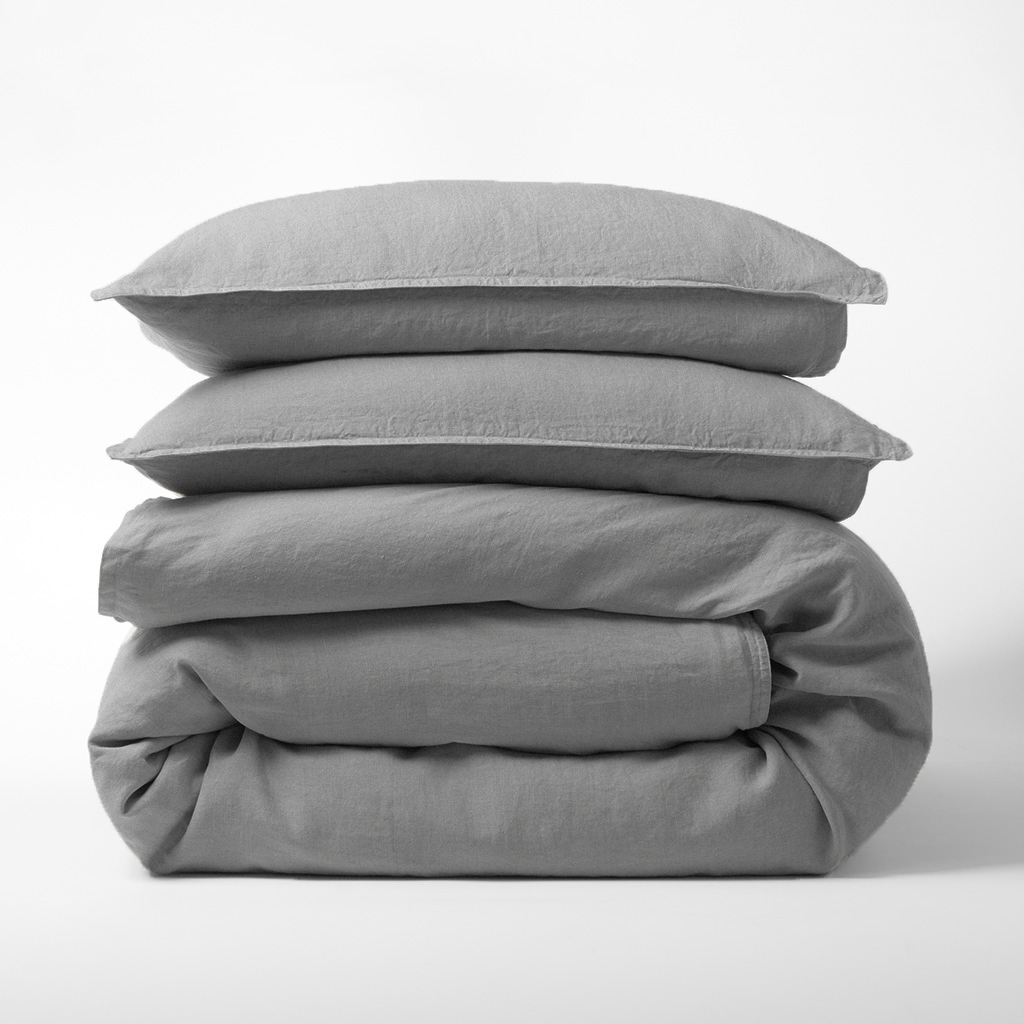 Stacked grey washed-linen duvet cover and two shams.