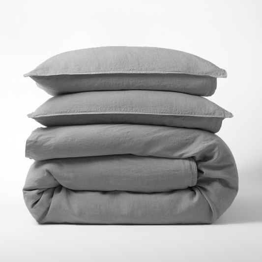 Stacked grey washed-linen duvet cover and two shams.