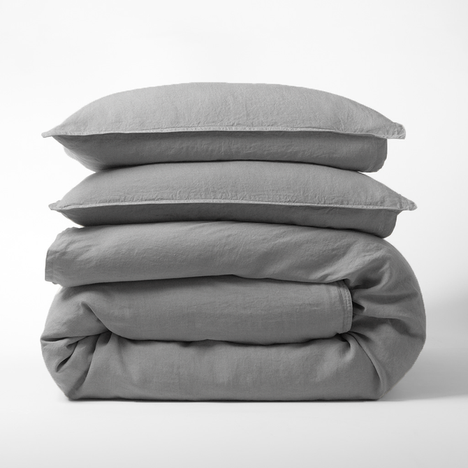 Stacked grey washed-linen duvet cover and two shams.
