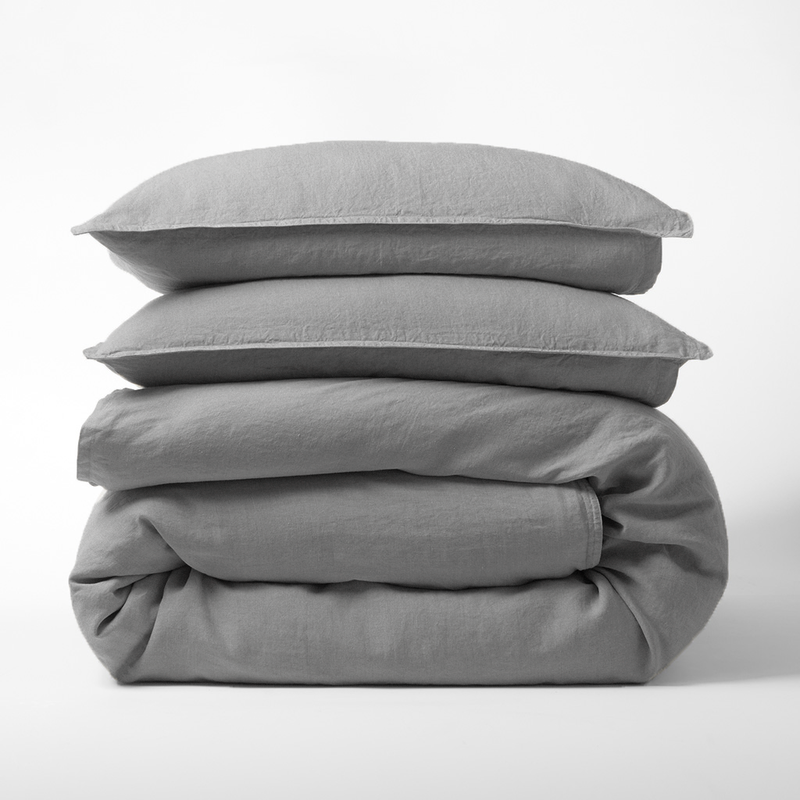 Stacked grey washed-linen duvet cover and two shams.