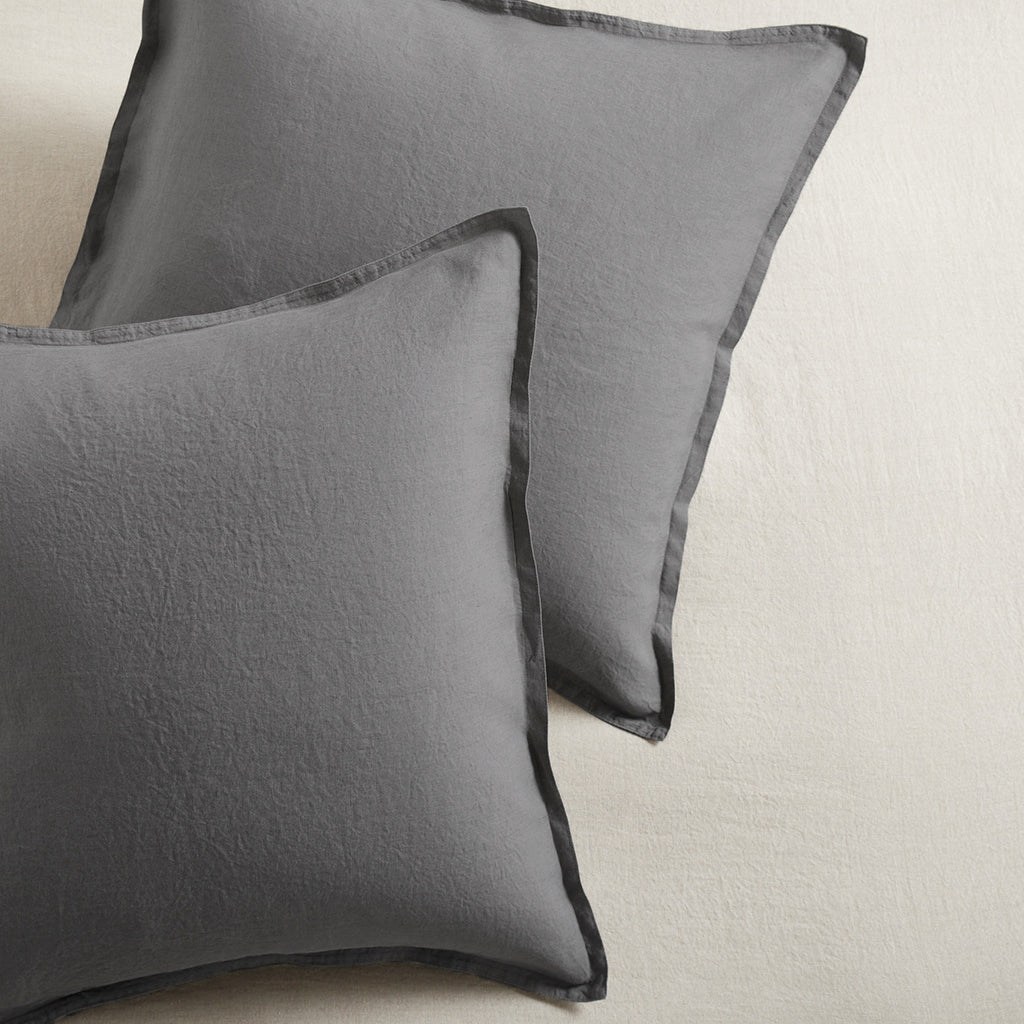 Set of 2 grey washed-linen pillow shams with a 2-inch flange and double-needle stitching.