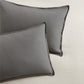 Set of two grey washed-linen pillow shams with 2" flange and double-needle stitching.