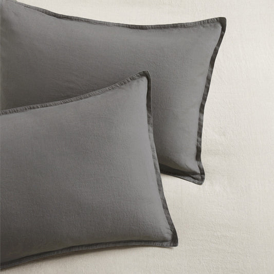 Set of two grey washed-linen pillow shams with 2" flange and double-needle stitching.