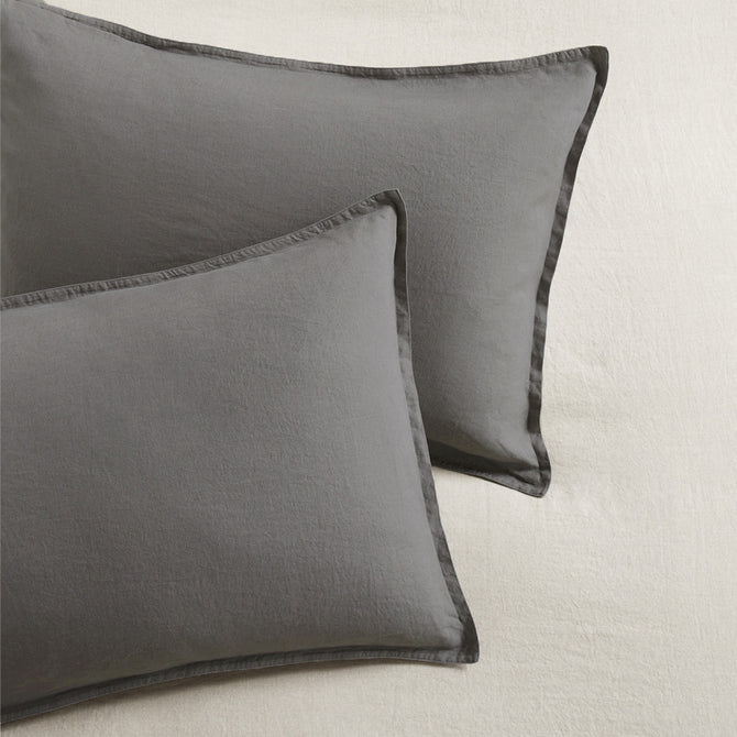 Set of two grey washed-linen pillow shams with 2" flange and double-needle stitching.