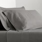 Grey Washed-Linen Sheet Set with two pillowcases and a fitted sheet, showing the fabric's texture.