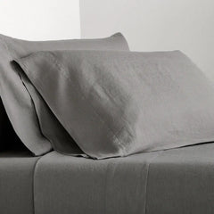 Grey Washed-Linen Sheet Set with two pillowcases and a fitted sheet, showing the fabric's texture.