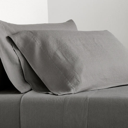 Grey Washed-Linen Sheet Set with two pillowcases and a fitted sheet, showing the fabric's texture.