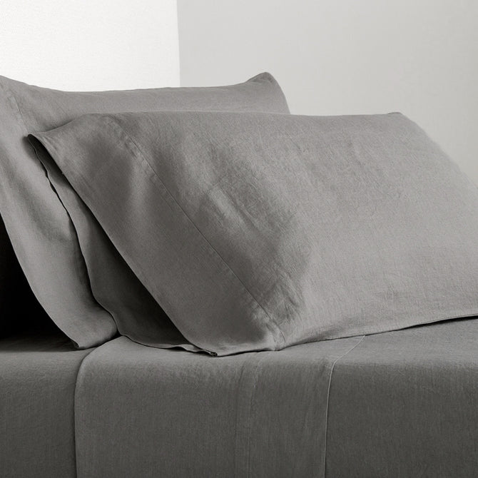 Grey Washed-Linen Sheet Set with two pillowcases and a fitted sheet, showing the fabric's texture.