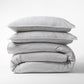 Stacked Grey Stripe Cotton-Chambray Duvet Cover and two pillow shams with thin stripes.