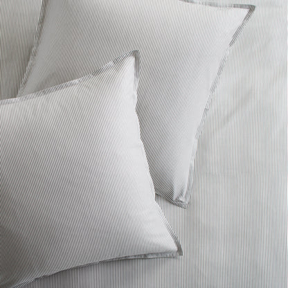 Set of 2 grey stripe cotton-chambray pillow shams with 2” flange and double-needle stitching.