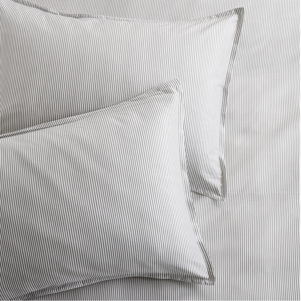 Set of 2 grey stripe cotton-chambray pillow shams with thin stripes and a 2” flange.