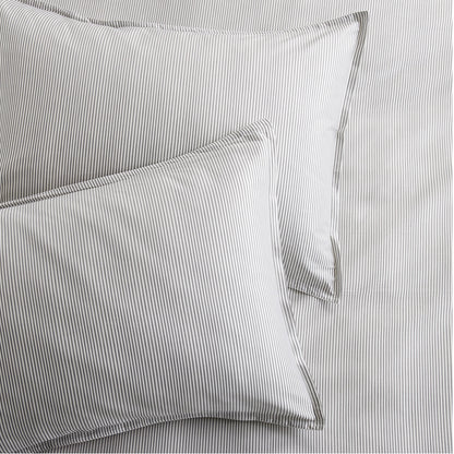 Set of 2 grey stripe cotton-chambray pillow shams with thin stripes and a 2” flange.