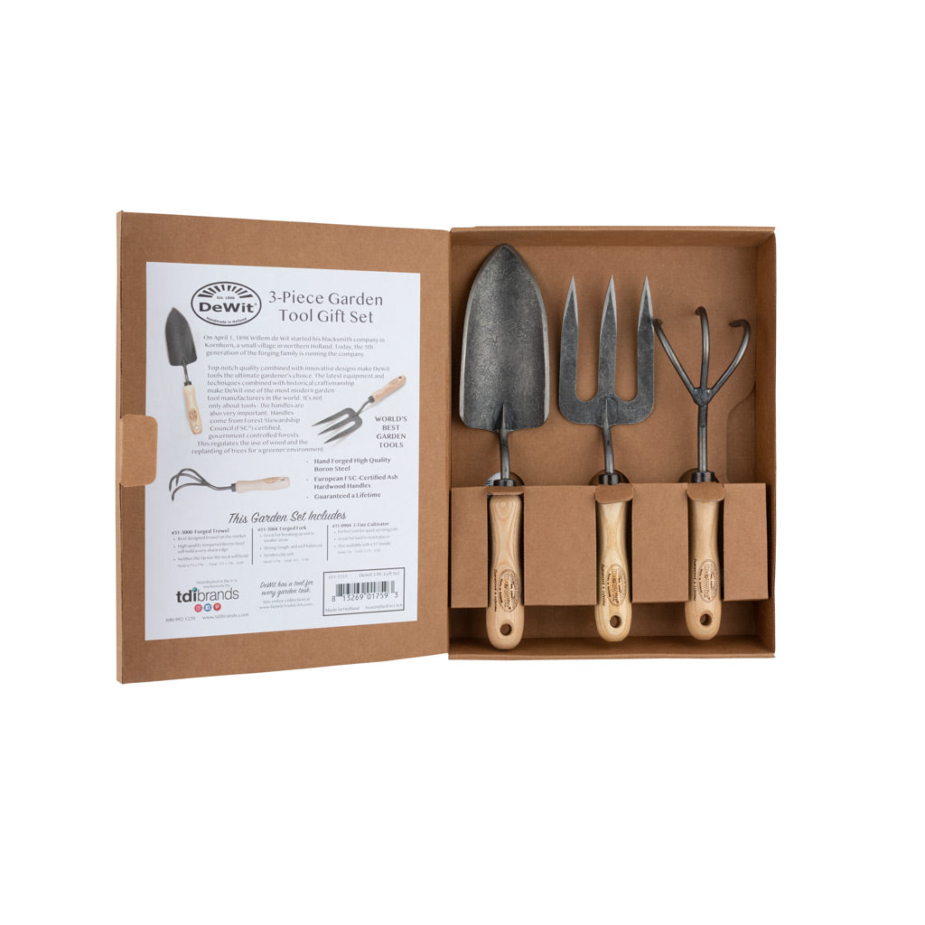 3-Piece Hand-Forged Garden Tool Gift Set with steel trowel, fork, and cultivator, all with ash hardwood handles, in a brown box.