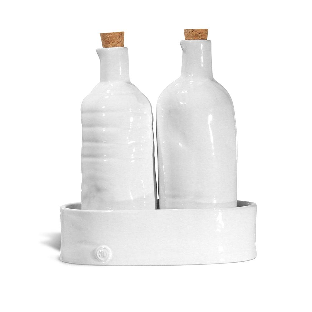 Handmade creamy white ceramic oil and vinegar cruets with corks in a matching tray by Montes Doggett.