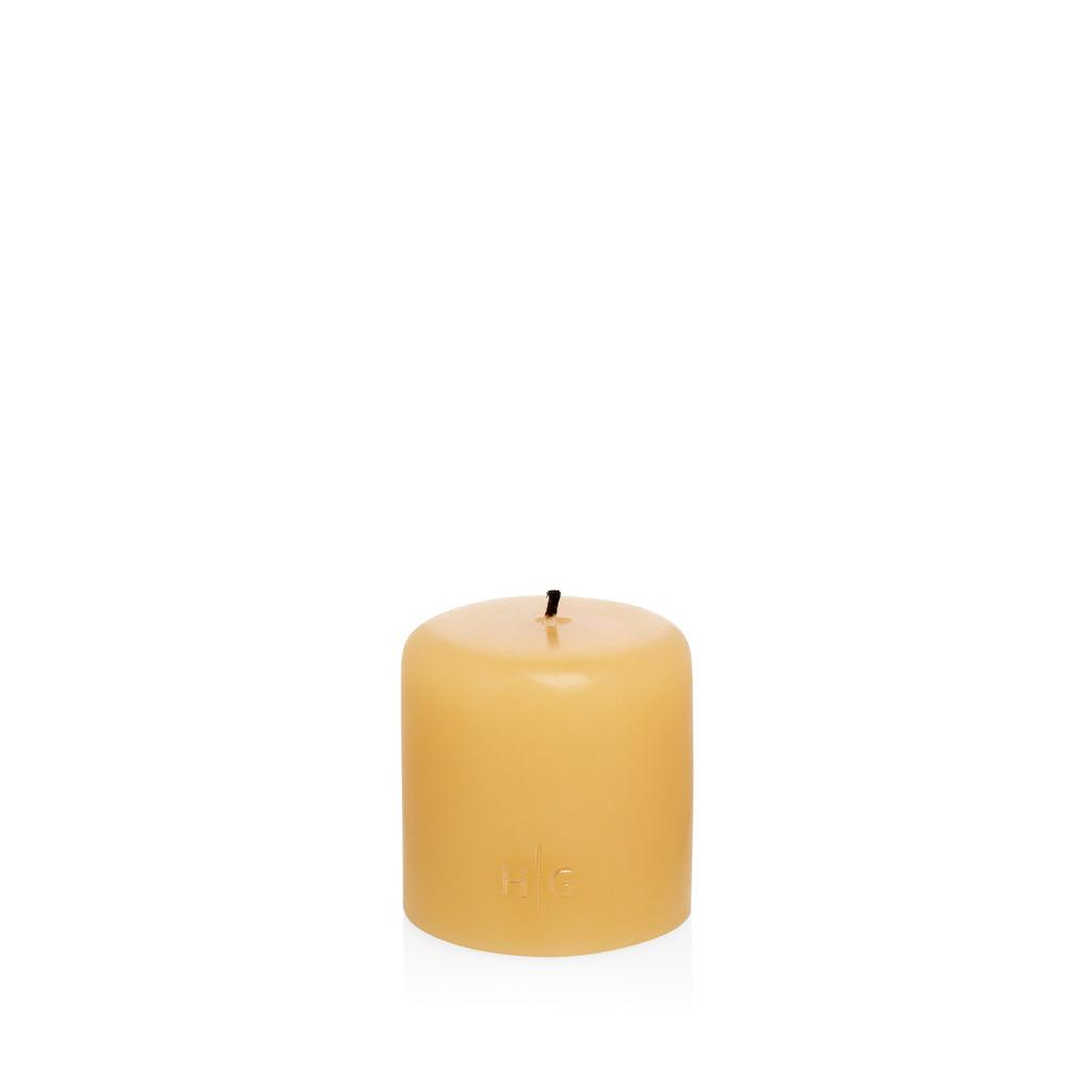 HG Amber Unscented Pillar Candle, 3"x3", with a gold embossed HG logo.