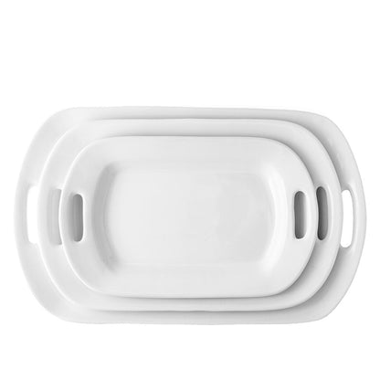Set of 3 white ceramic serving platters with handles, nested from small to large.