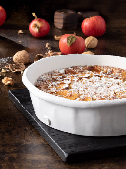 HG Handmade Ceramic Round Baking Dish by Montes Doggett, creamy white, filled with a baked dessert.