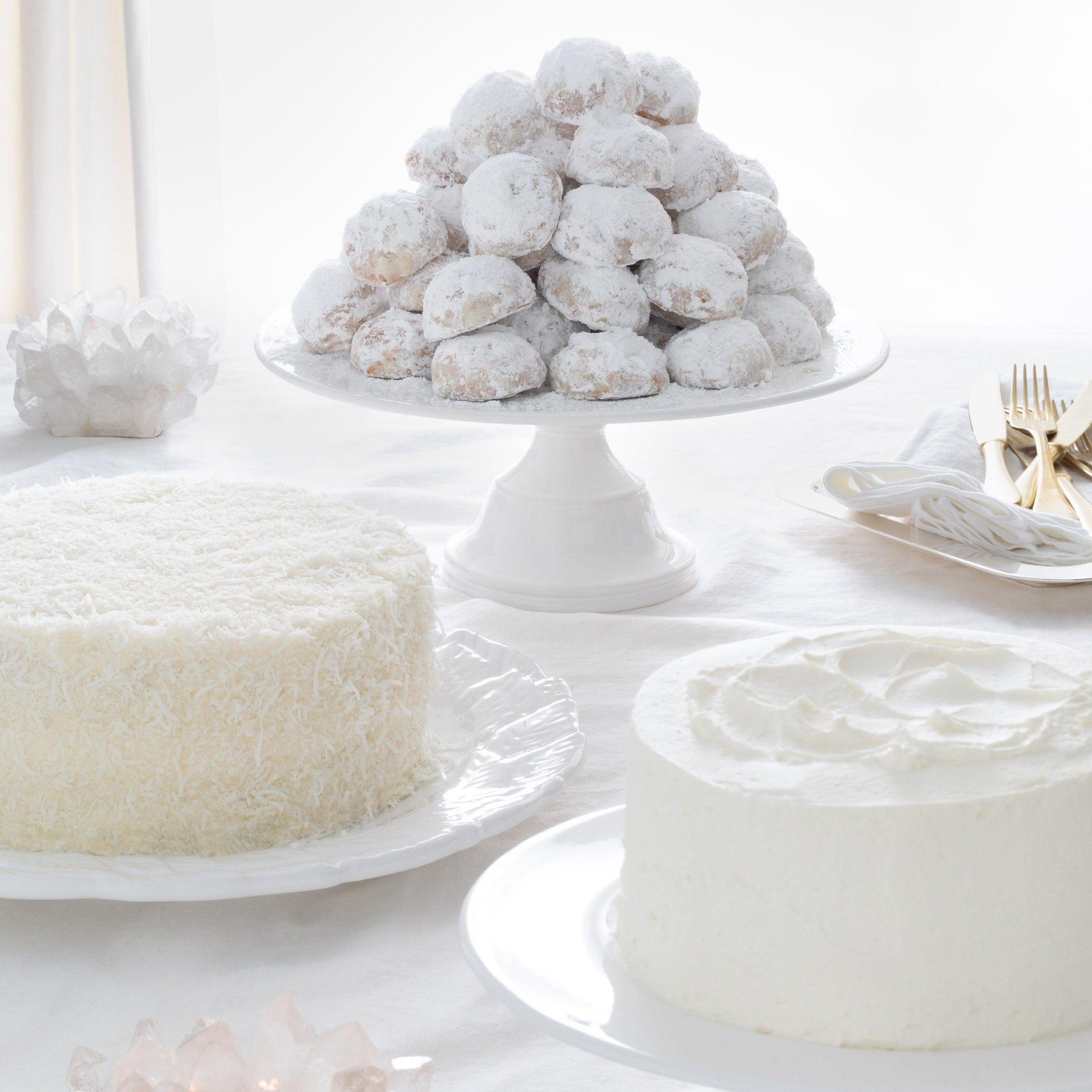 White ceramic HG Original Large Pedestal Cake Stand holding powdered sugar cookies.