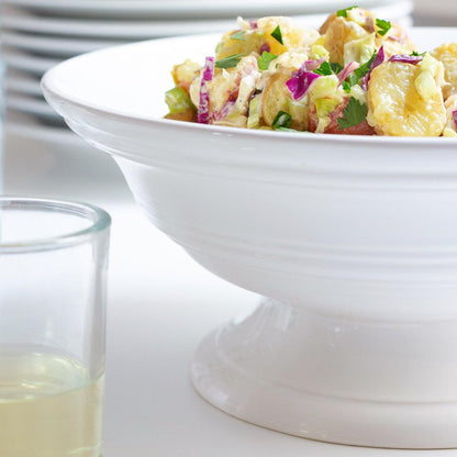 White ceramic footed bowl, 11.5"Dia x 6"H, filled with potato salad.