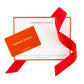 Hudson Grace orange gift card with white notecard and red ribbon.