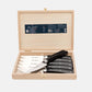 Jean Dubost black handled steak knives, set of 6, in an open light wood gift box.