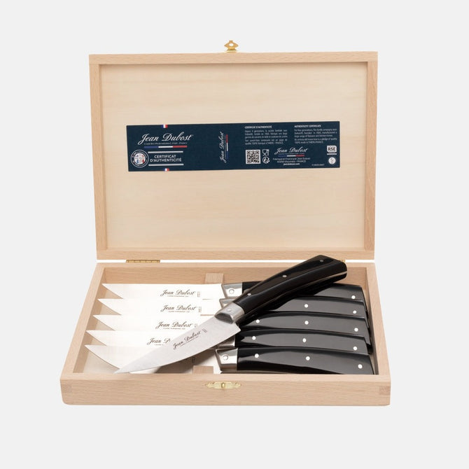 Jean Dubost black handled steak knives, set of 6, in an open light wood gift box.