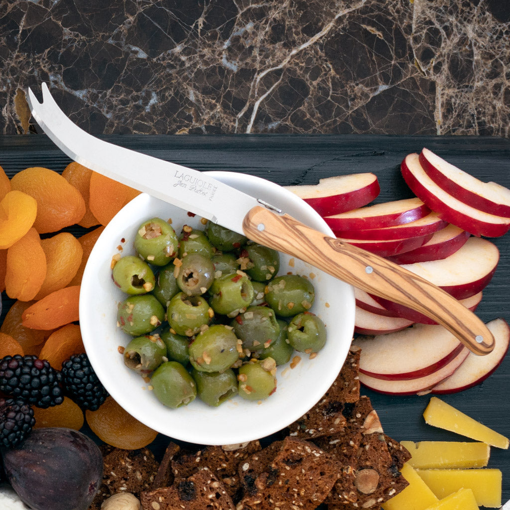 Jean Dubost Olive Wood 3-piece cheese knife set with stainless steel blades, olivewood handle, on a cheese board.
