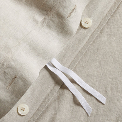 Close-up of a Khaki Washed-Linen Duvet Cover showing a hidden-button closure, corner ties, and natural texture.