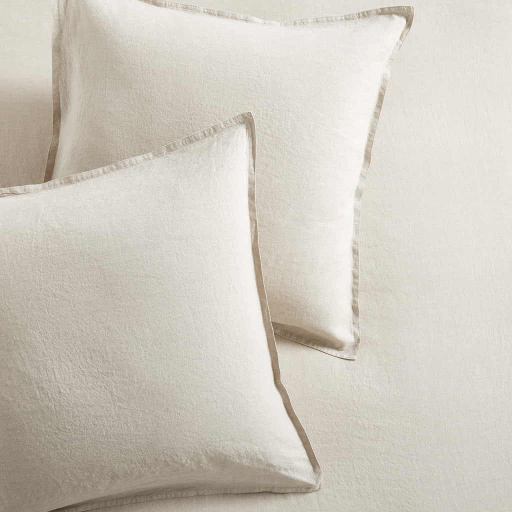 Two Khaki Washed-Linen Pillow Shams with 2" flange and double-needle stitching, on a matching linen bed.
