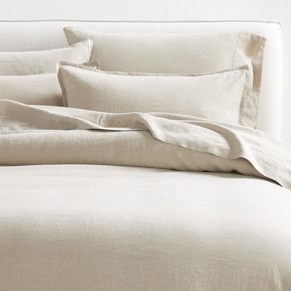 Khaki washed-linen pillow shams and duvet cover on a bed, showing the relaxed texture and 2" flange.
