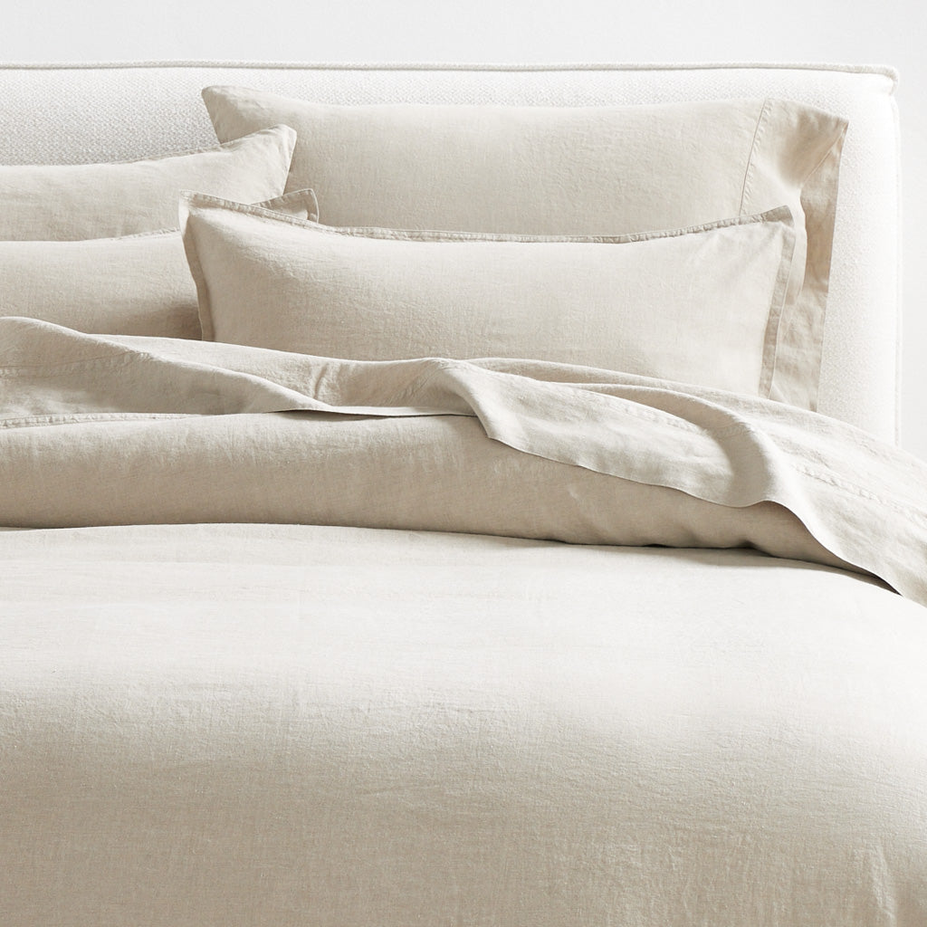 Khaki Washed-Linen Sheet Set with flat sheet, fitted sheet, and pillowcases on a bed.