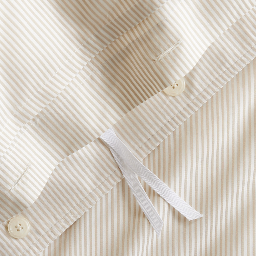 Khaki stripe cotton-chambray duvet cover with hidden-button closure, corner ties, and double-needle stitching.