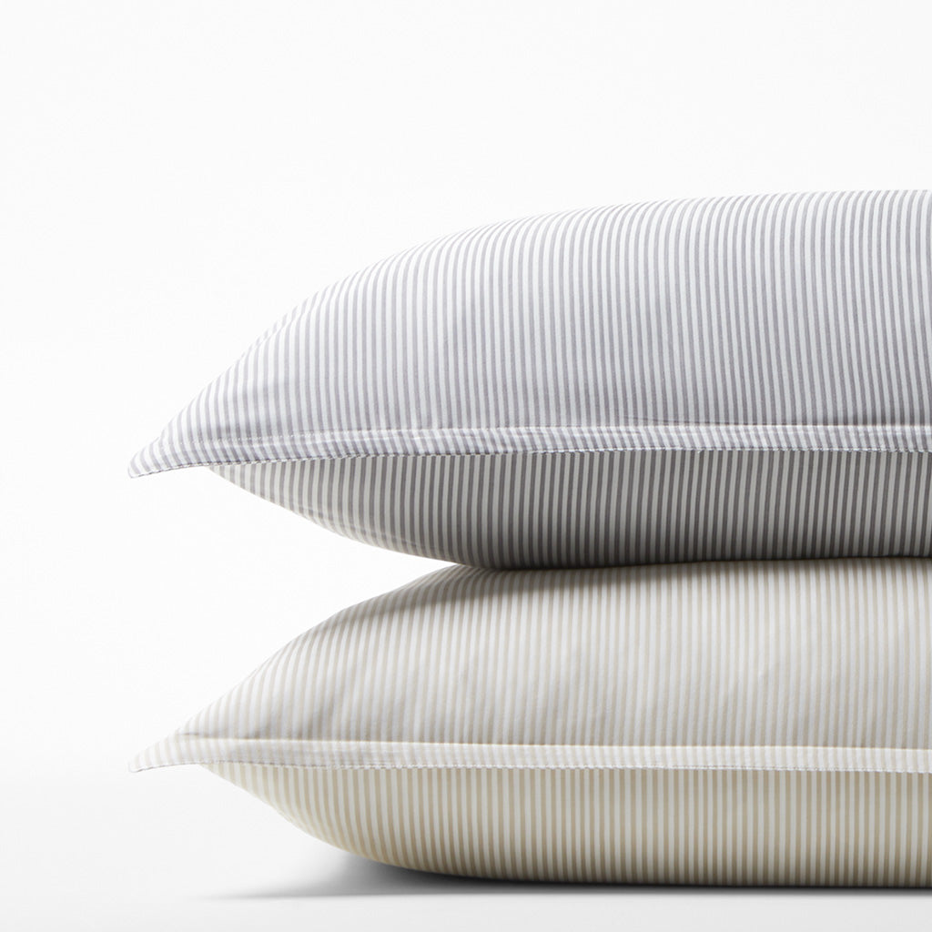 Stack of two Khaki Stripe Cotton-Chambray Pillow Shams with thin vertical stripes.
