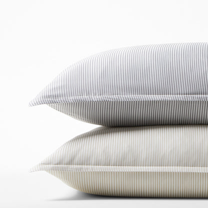 Stack of two Khaki Stripe Cotton-Chambray Pillow Shams with thin vertical stripes.