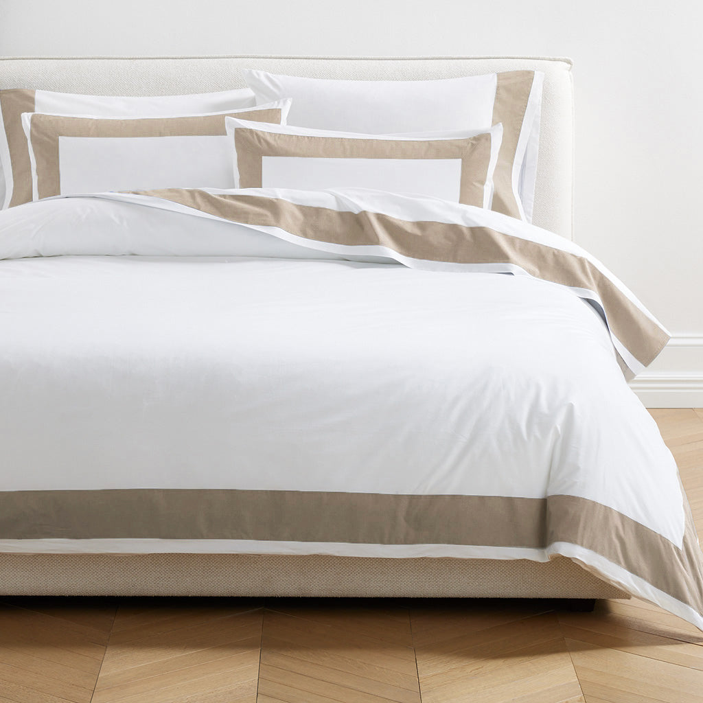 Khaki Wide-Band Percale Sheet Set on a bed, featuring white sheets with a 4-inch khaki border.
