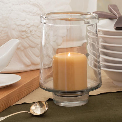 Large clear glass Antwerp Hurricane candle holder with a lit pillar candle.