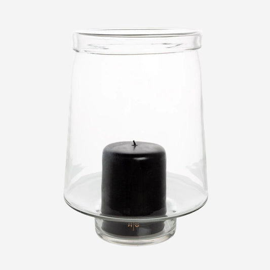 Large Antwerp clear glass hurricane candle holder with a black pillar candle inside.