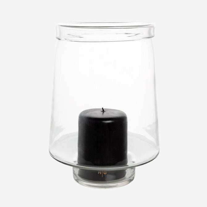 Large Antwerp clear glass hurricane candle holder with a black pillar candle inside.