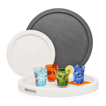 Large black and small white round wood serving trays with colorful drinks.