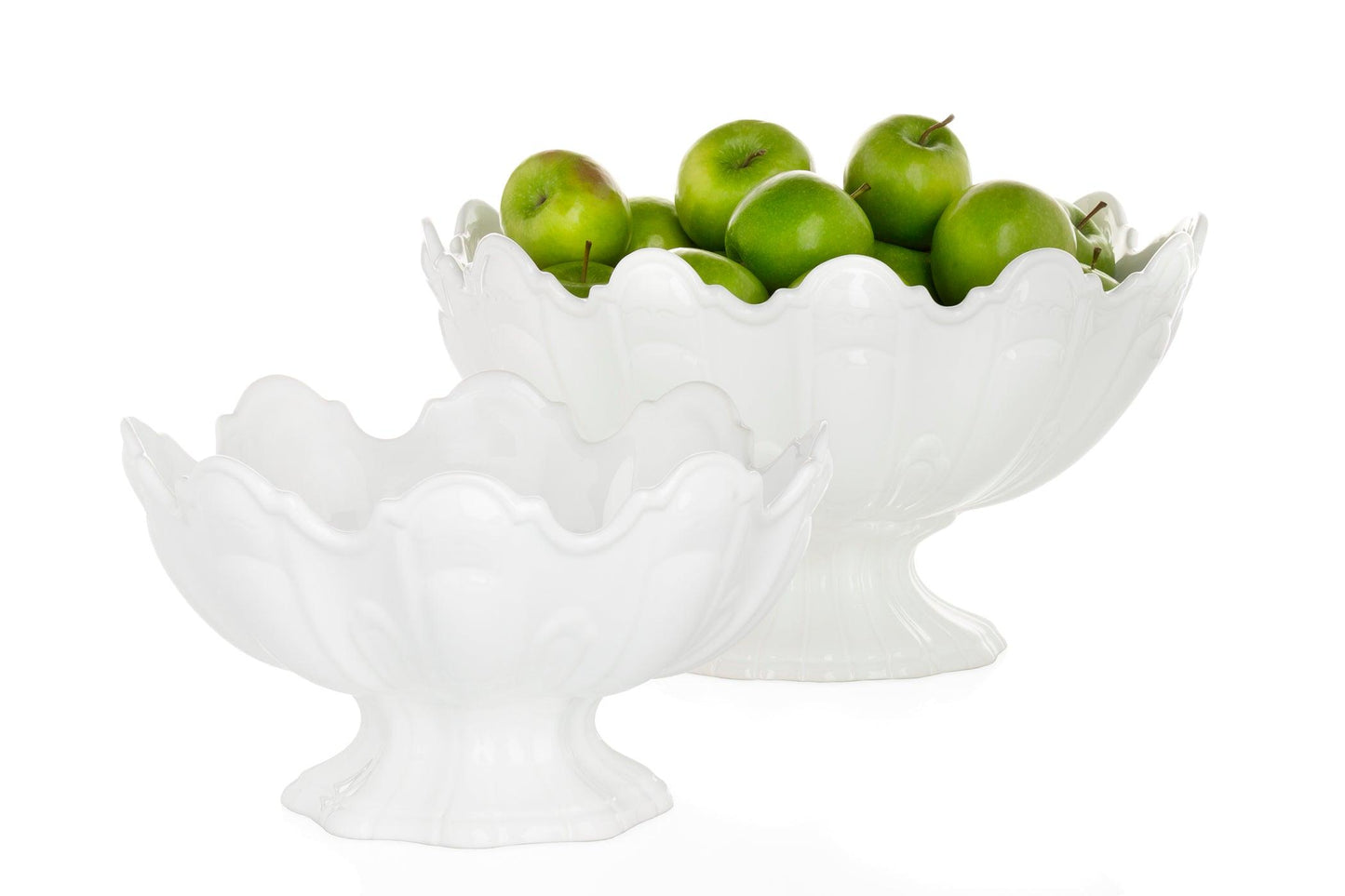 Two white ceramic scallop serve bowls, one large with green apples, one smaller empty.