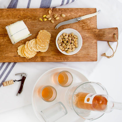 Large Farmtable Wood Serving Plank with cheese, crackers, and pistachios, beside rosé wine.